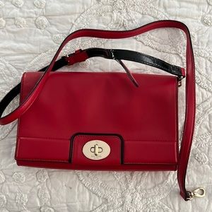Red leather clutch with strap. Hardly used. Interior zip pocket and slots.
